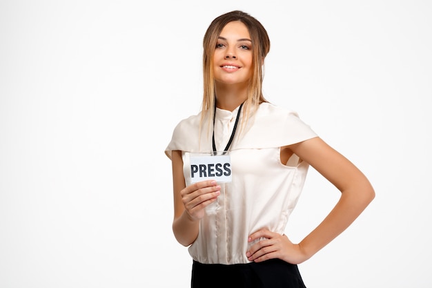 Portrait of young successful businesswoman over white background.