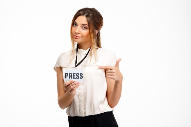Portrait of young successful businesswoman over white background.