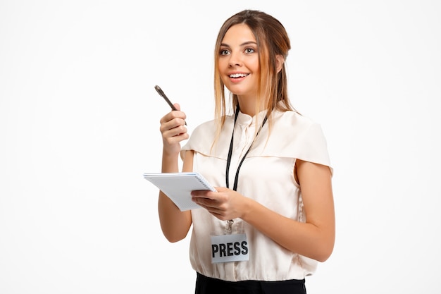 Portrait of young successful businesswoman over white background.