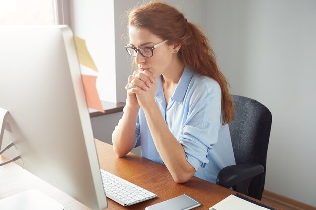 Portrait of young successful female boss reflecting on her business goals