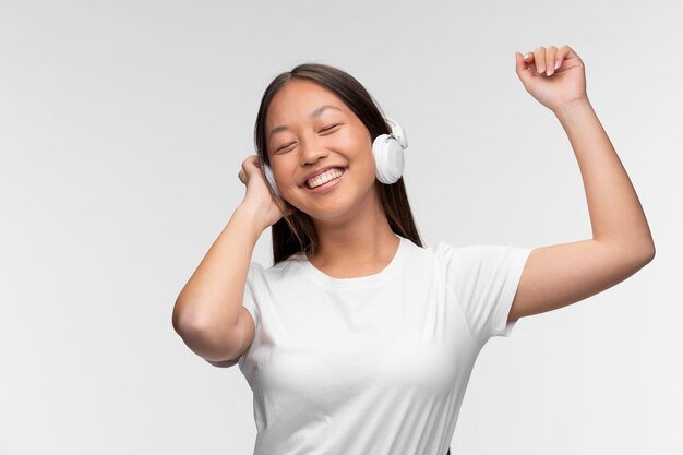 Portrait of young teenage girl with headphones listening to music