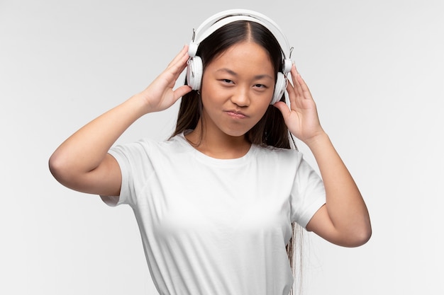 Portrait of young teenage girl with headphones listening to music