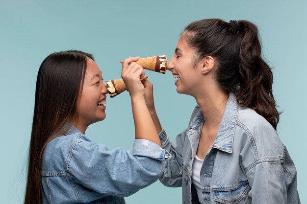 Portrait of young teenage girls posing together with ice creams