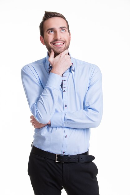 Portrait of the young thinking man looks up in casuals isolated