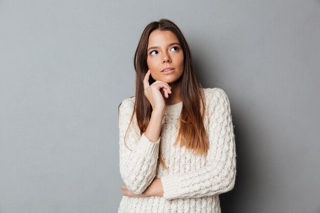 Portrait of a young thoughtful girl in sweater