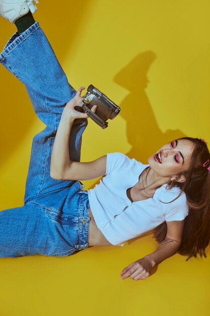 Portrait of young woman in 2000s fashion style posing with camera