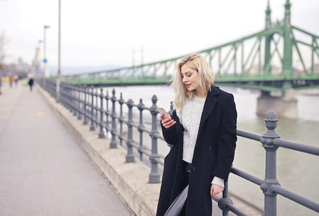 portrait of young woman in a black coat in the street