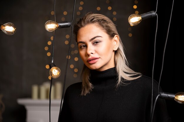 Portrait of young woman in black sweater standing and posing.