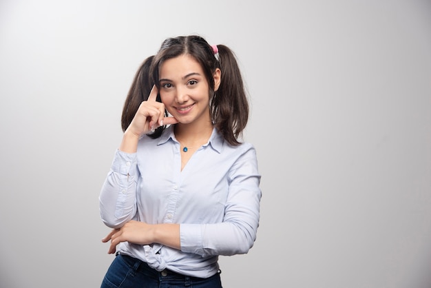 Portrait of young woman in blue blouse posing. 