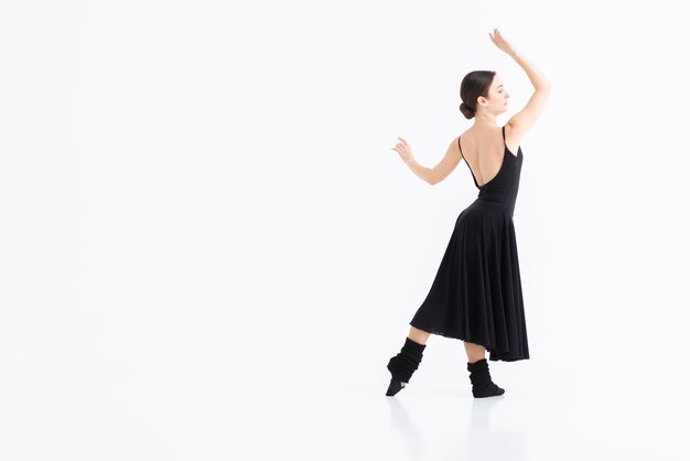 Portrait of young woman dancing with elegance