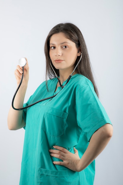 Portrait of a young woman doctor with stethoscope in uniform. 
