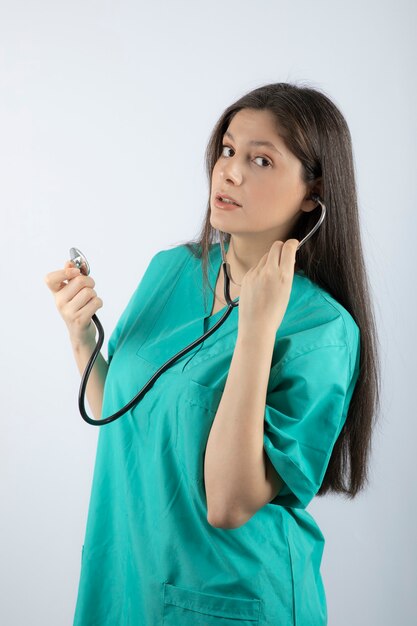 制服を着た聴診器を持つ若い女性医師の肖像画。