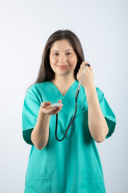 Portrait of a young woman doctor with stethoscope in uniform. 