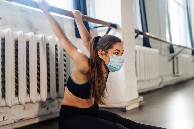 Portrait of a young woman doing exercises at gym