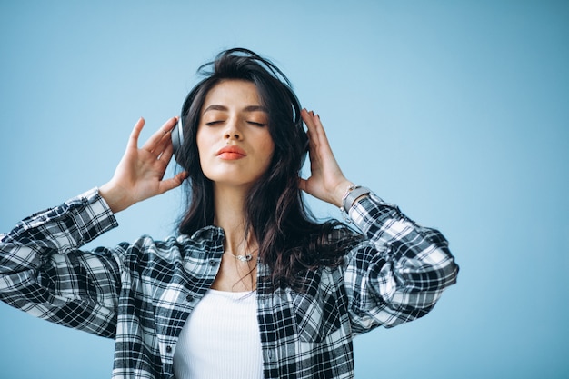 Free photo portrait of a young woman in earphones listening to music