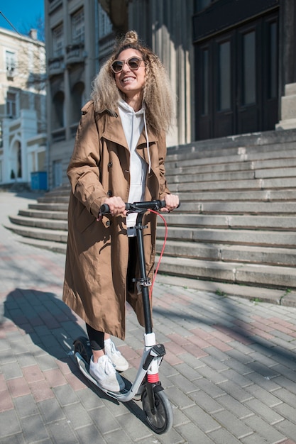 Portrait of young woman on electric scooter