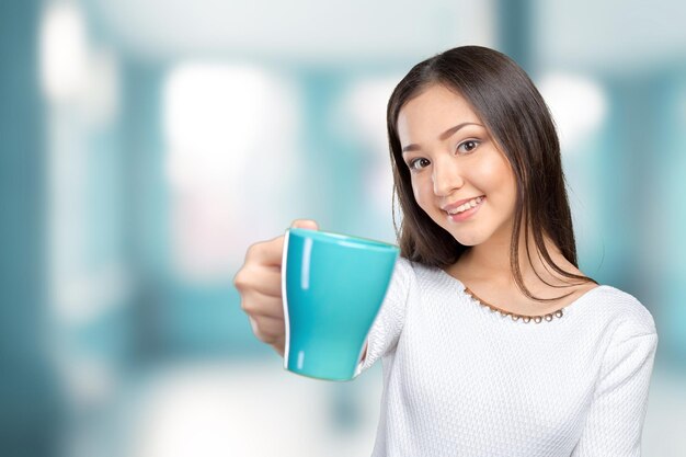 Portrait of young woman having coffee