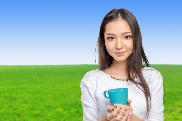 Portrait of young woman having coffee