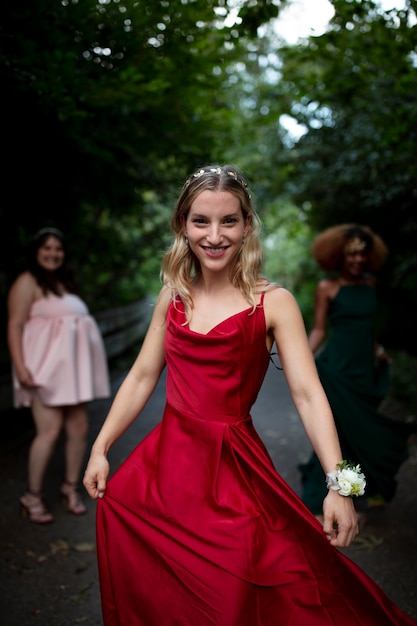 Portrait of young woman next to her friends at prom