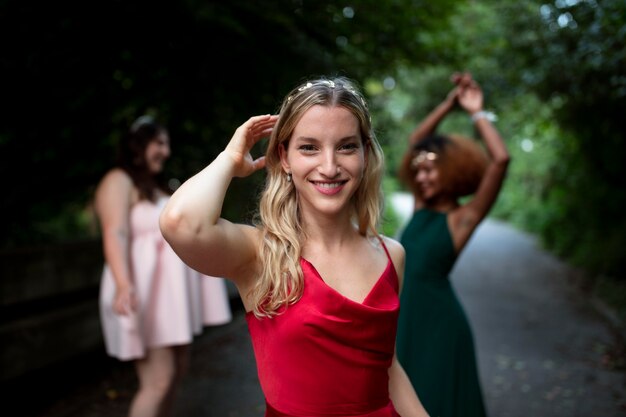 Portrait of young woman next to her friends at prom