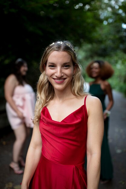 Portrait of young woman next to her friends at prom