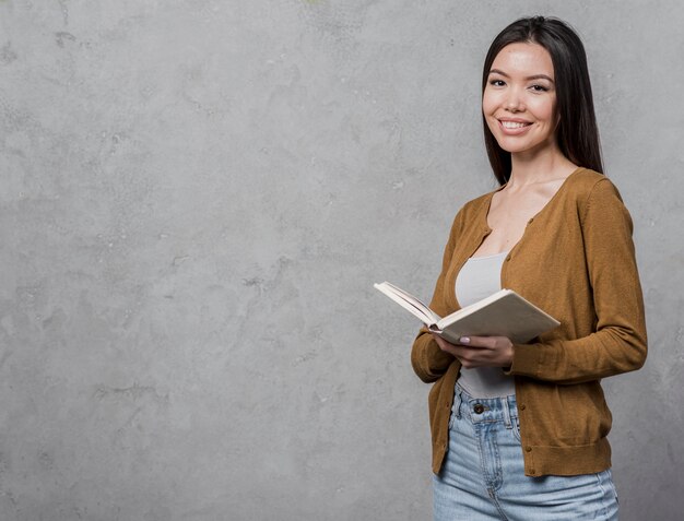 Portrait of young woman holding a book