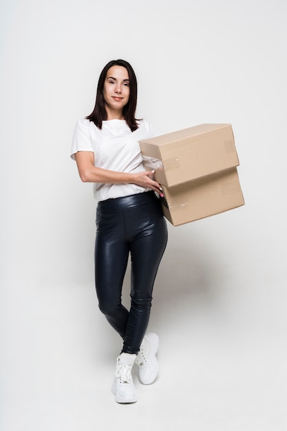 Portrait of young woman holding cardboard boxes