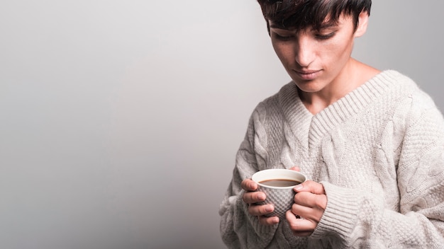 Portrait of young woman holding coffee cup