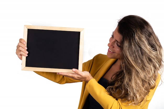 Portrait of young woman holding an empty chalkboard