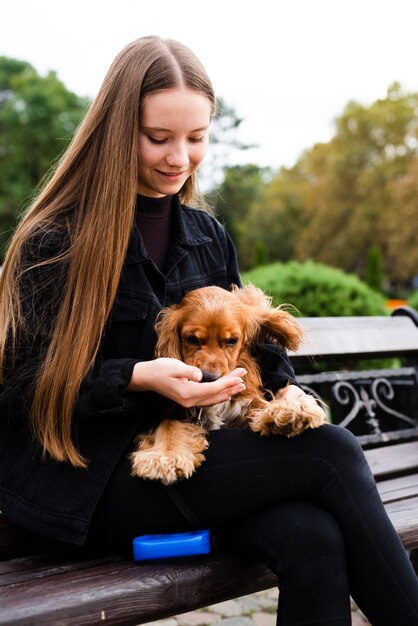 Portrait of young woman holding her dog