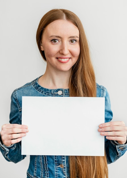 Portrait young woman holding paper sheet