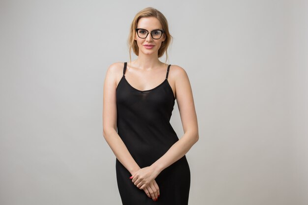 Portrait of young woman isolated on white wearing glasses in confident pose and wearing black dress