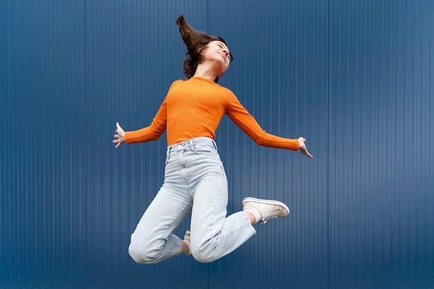 Free photo portrait young woman jumping