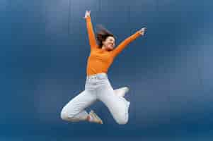 Free photo portrait young woman jumping