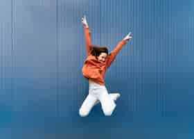 Free photo portrait young woman jumping