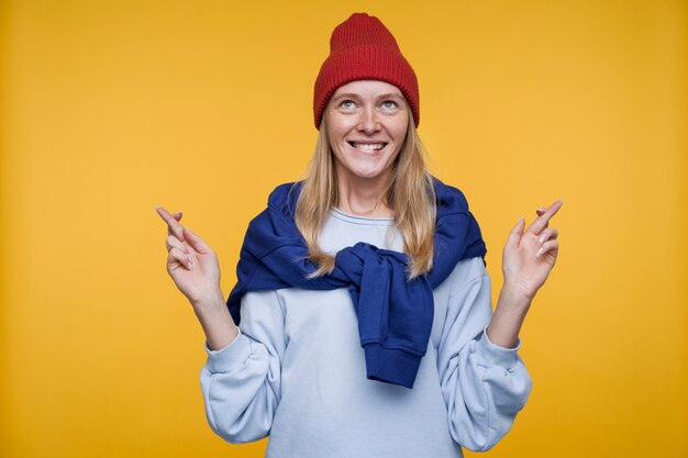 Portrait of a young woman keeping her fingers crossed