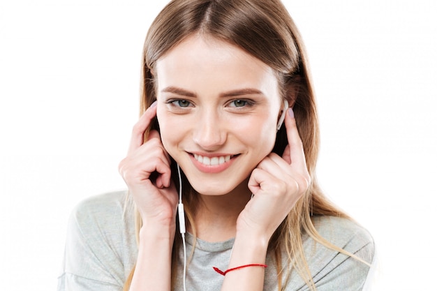 Portrait of young woman listening music