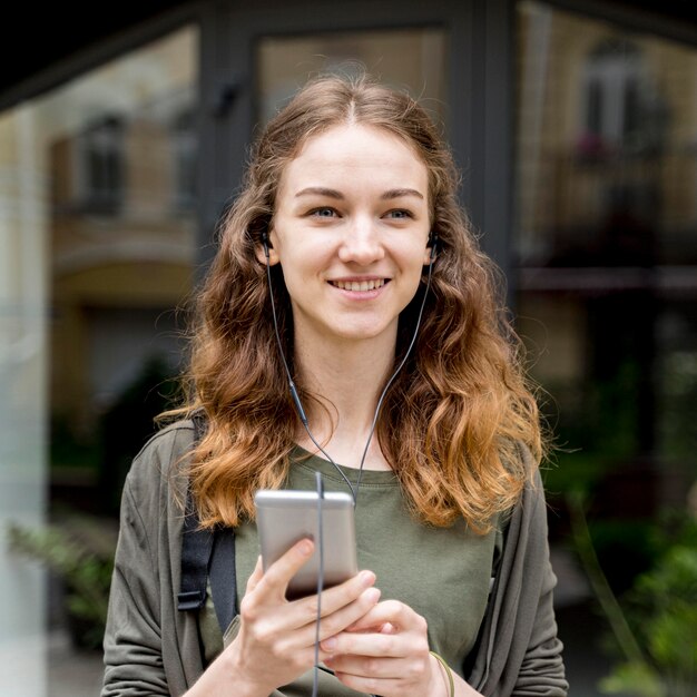 Portrait young woman listening music