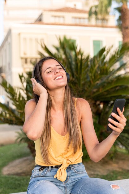 Portrait of young woman listening to music