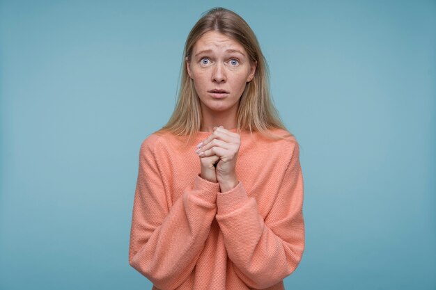 Portrait of a young woman looking scared