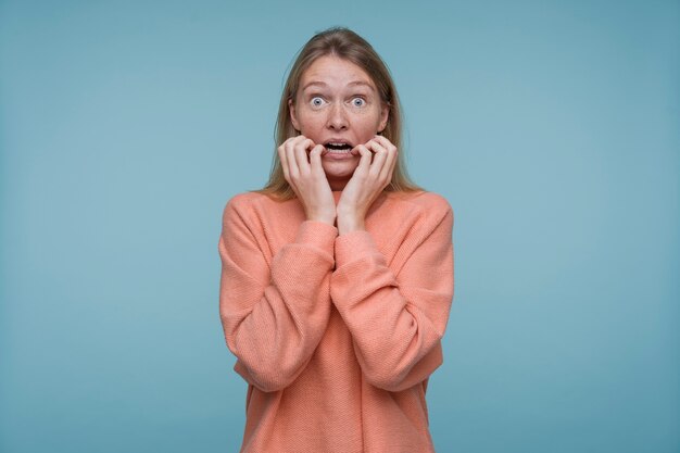 Portrait of a young woman looking terrified