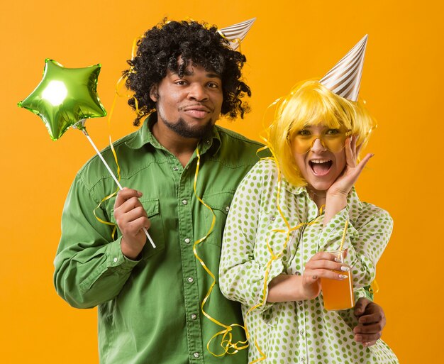 Portrait young woman and man with party balloon