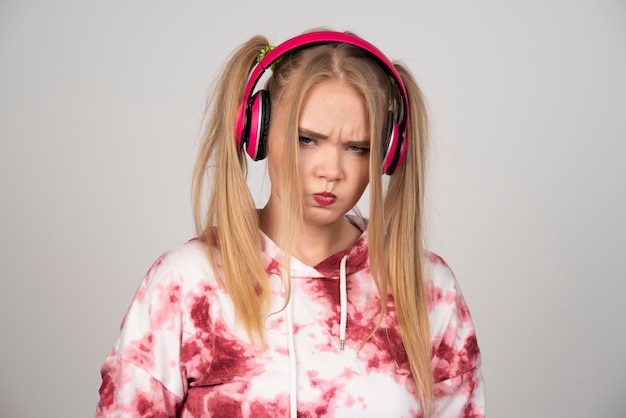 Portrait of young woman in pink outfit looking seriously.