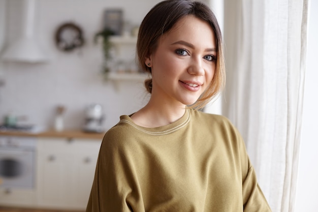 Portrait of a young woman posing in the house