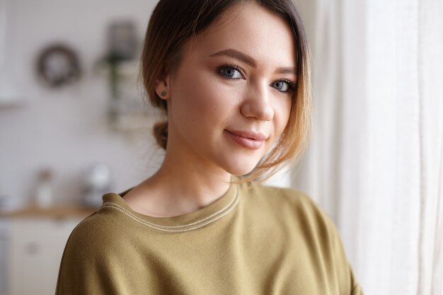 Portrait of a young woman posing in the house