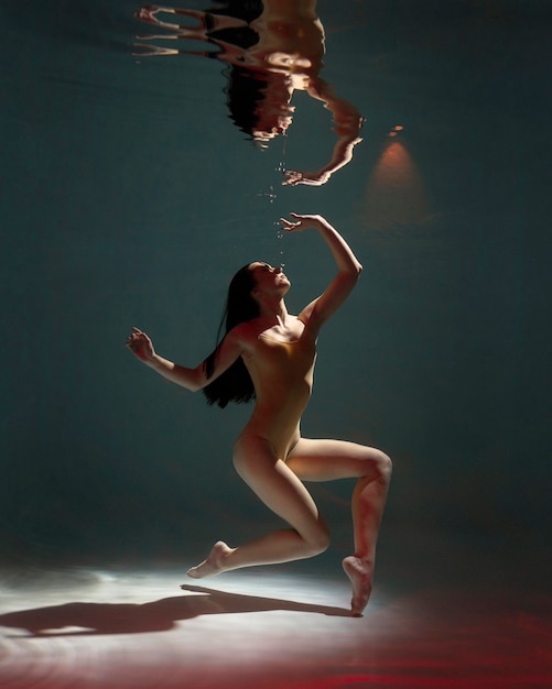 Free photo portrait of young woman posing submerged underwater