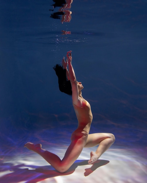 Portrait of young woman posing submerged underwater