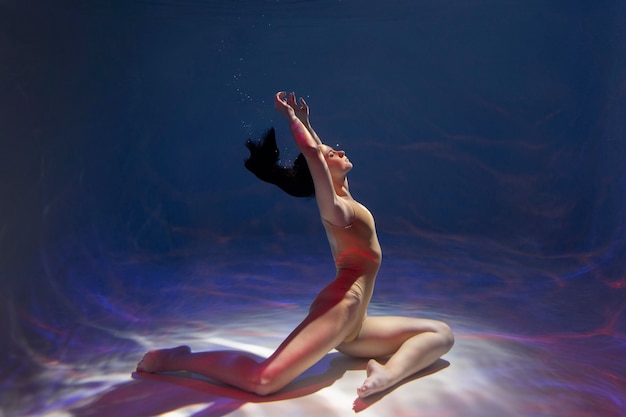 Portrait of young woman posing submerged underwater