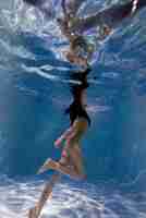 Free photo portrait of young woman posing submerged underwater