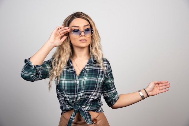 Portrait of young woman posing with stylish glasses. 